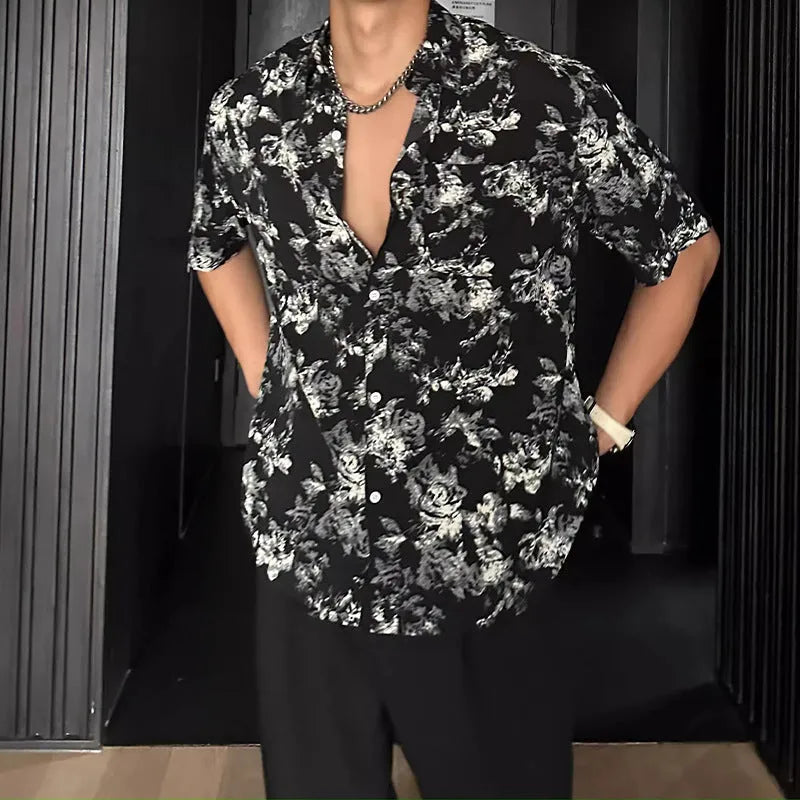 A loose-fitting, short sleeve casual shirt with a floral print, shown in a cardigan style.
