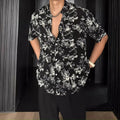 A loose-fitting, short sleeve casual shirt with a floral print, shown in a cardigan style.