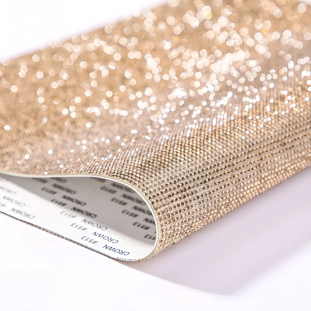 Sheet of rhinestones on net backing with hot drill glue, showing multiple colour options including AB and rose gold.
