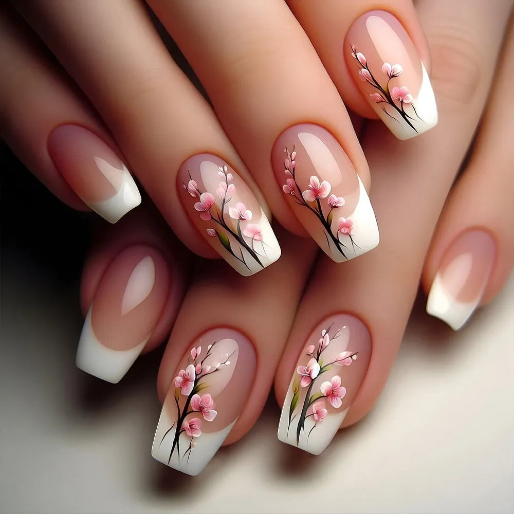 Plum blossom style nail tips with simple white edge French design and starry sky pattern on a table
