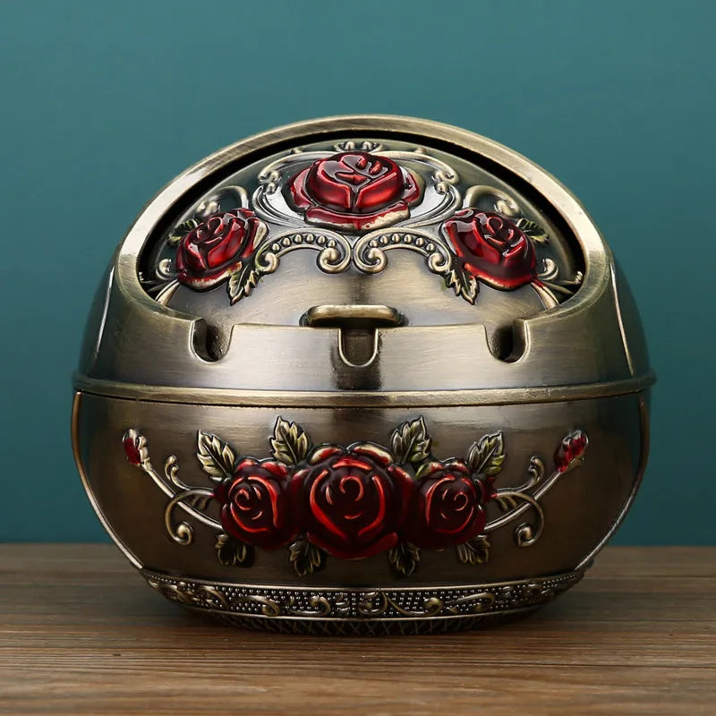 Alloy decorative ashtray in bronze with ornate peacock motif and cigarette extinguishing slot.