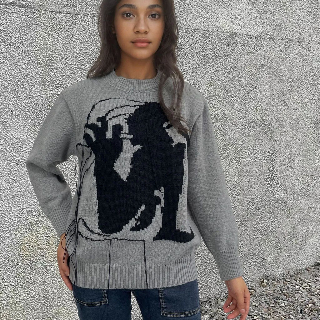 Grey women's loose alpaca wool sweater with tassel detailing and abstract pattern