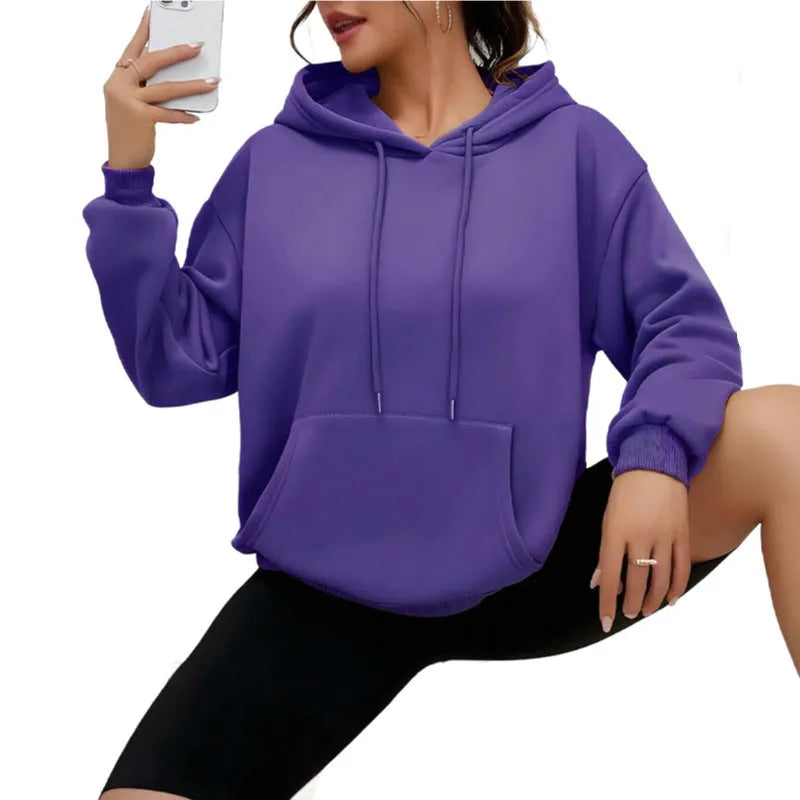 Women's loose grey hooded sweatshirt with a front pocket and drawstring.