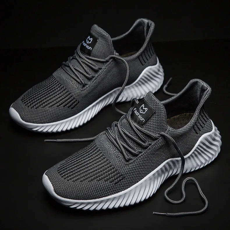 Large size men's breathable running shoes with white Hida upper and MD sole on grey background