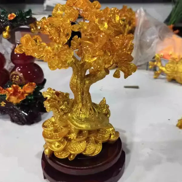 Citrine-coloured resin ornament of a turtle money tree in Chinese Feng Shui style.
