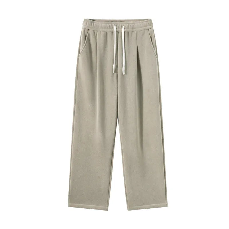 Men's apricot fleece-lined casual sports trousers with a loose fit and drawstring waist, laid flat.