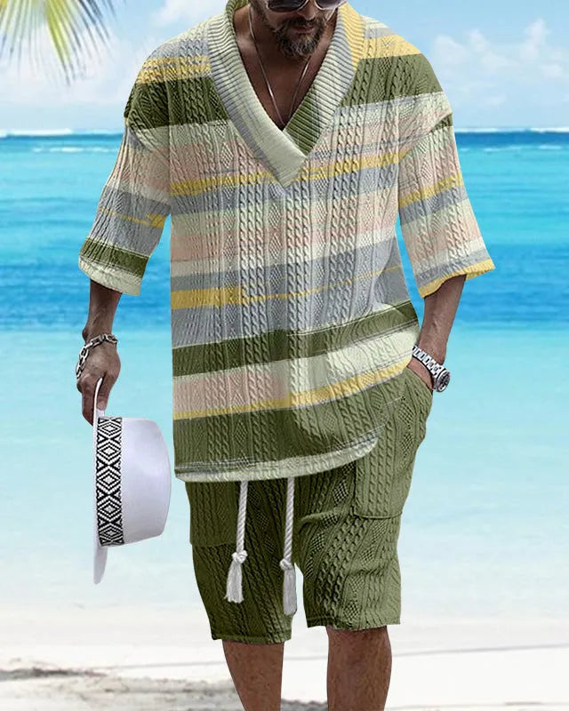 Man wearing a loose-fitting light blue short sleeve suit top and matching casual shorts.