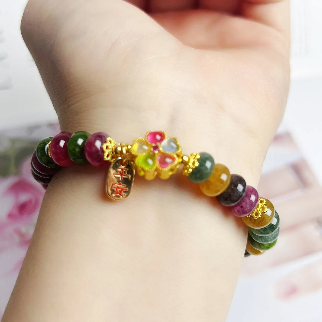 Women's bracelet with colourful tourmaline abacus beads and artificial crystal on wrist.