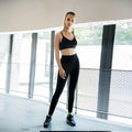 Women's loose breathable yoga pants sweat suit set in black, high-waist, 95% polyester blend, side view
