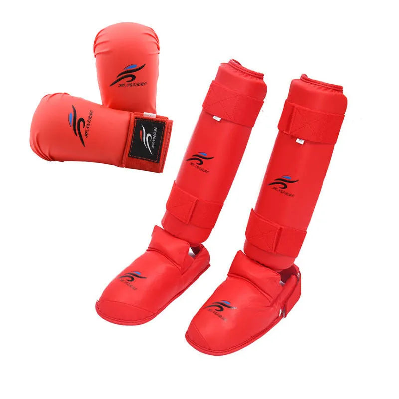 Red and blue karate protective gear set with helmet, boxing gloves and leg guards on training mat