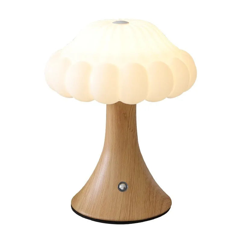 Wood grain coloured mushroom-shaped touch lamp with USB charging port on a bedside table.
