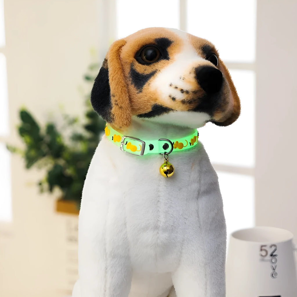 Silicone light-up cat collar with luminous fish bone and heart patterns on a pink background