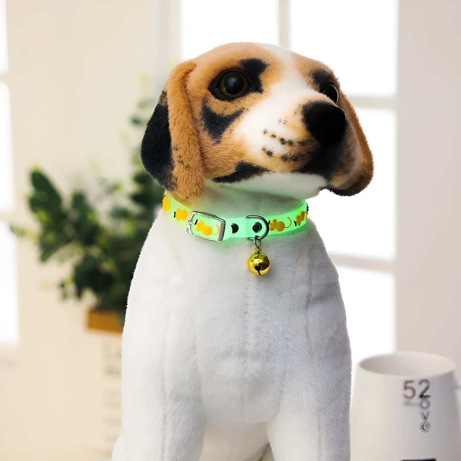 Silicone light-up cat collar with luminous fish bone and heart patterns on a pink background