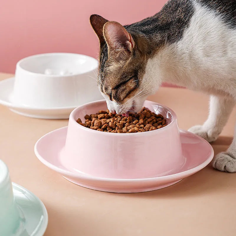 Green ceramic slow feeder pet bowl with raised centre and non-slip base.