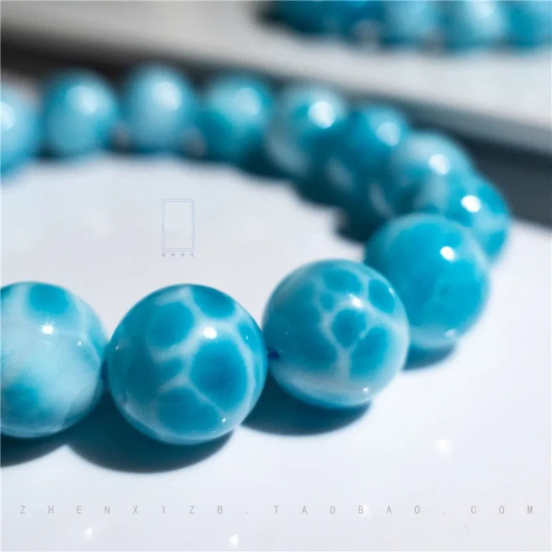 Blue manually crafted Bodhi bracelet with sea-pattern crystal stones and pearl details.
