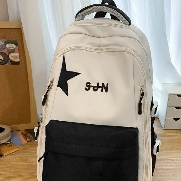 Mori style nylon backpack for women, light blue colour, shown with pendant on a plain background