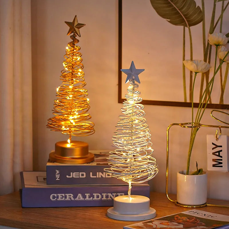 Wrought iron metal LED Christmas tree spiral light with warm white illumination on tabletop