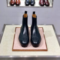 Black high top leather business casual shoes on a white background.