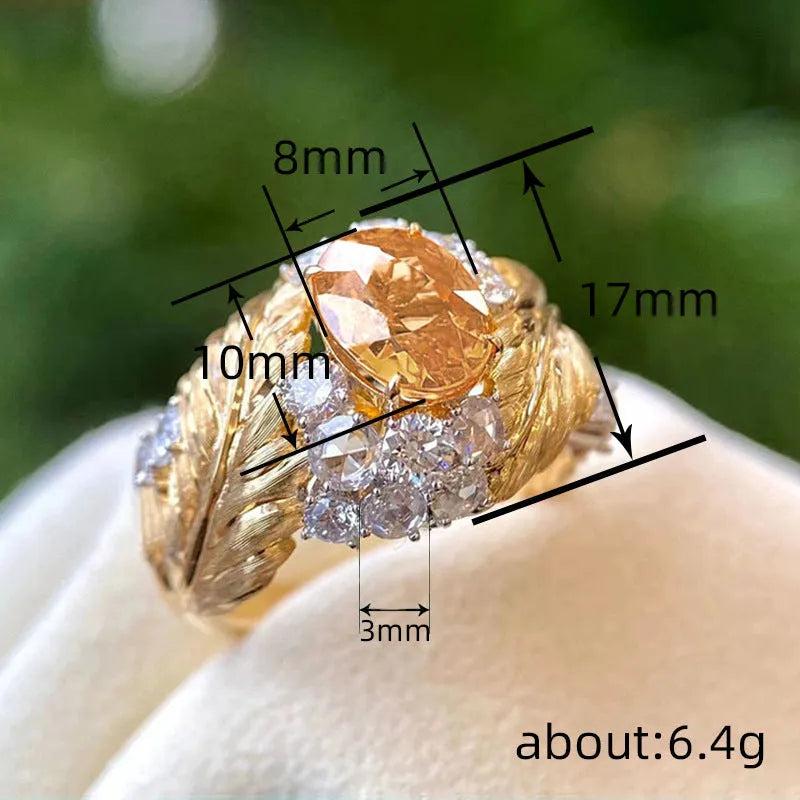 Gold women's ring with embossed feather pattern and yellow zircon stones on geometric copper band
