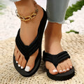 Black women's cotton flip-flop slippers with a ribbon detail on a flat EVA sole.