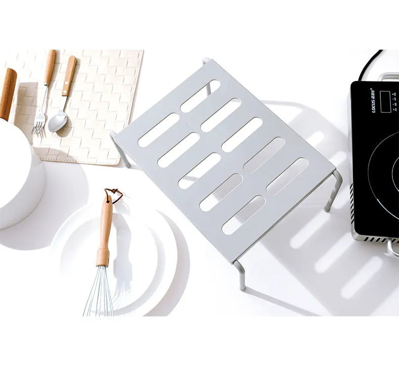 Retractable ABS rack with hollow grid design for kitchen, living room, or bathroom storage, available in grey or white