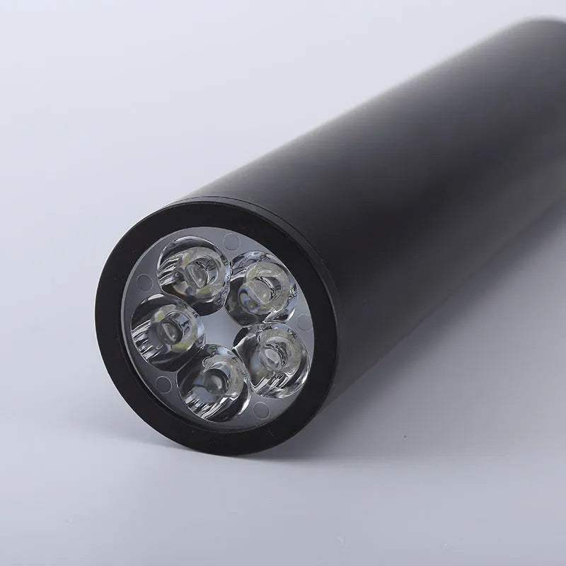 Black round surface mounted LED ceiling downlight spotlight in warm white or cool white light.