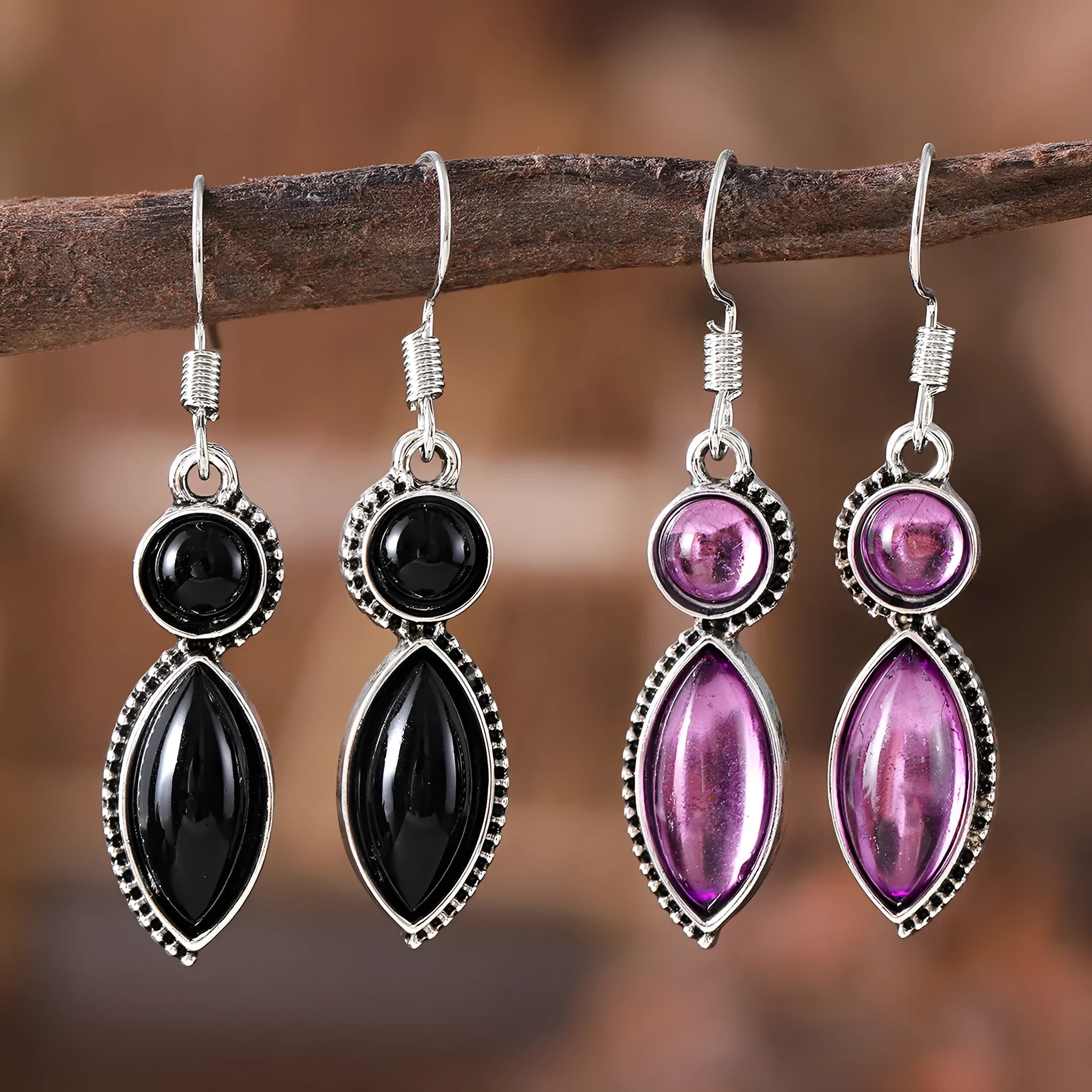 A pair of black and purple vintage geometric drop earrings with a round detail, shown against a plain background.