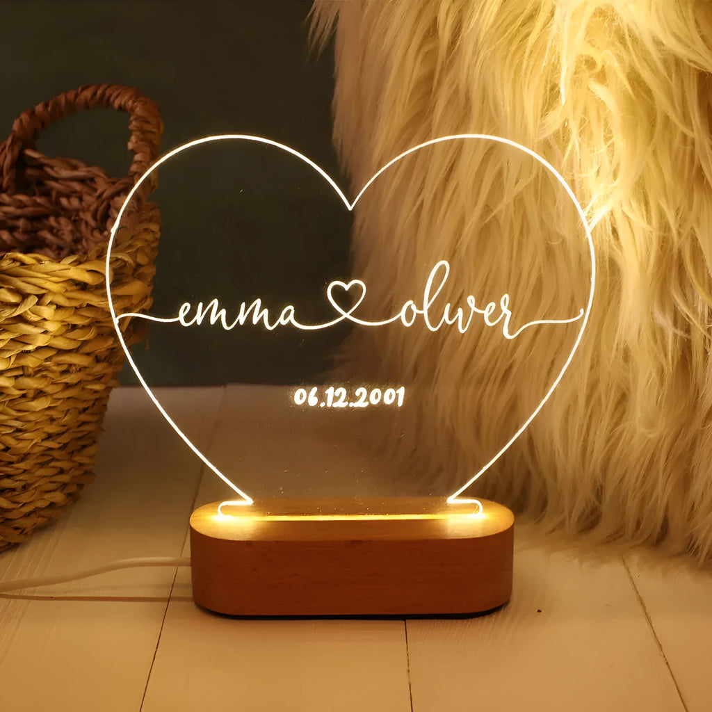 Custom transparent acrylic LED night light personalised with names and date, 20cm by 11.5cm.