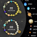 Set of two natural stone beaded bracelets with zodiac sign charms on a background.