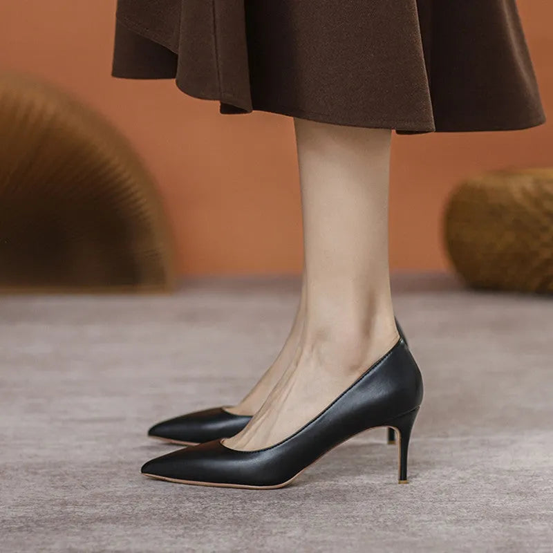 Black pointed-toe stiletto high heel pump shoes for wide feet on a plain background.