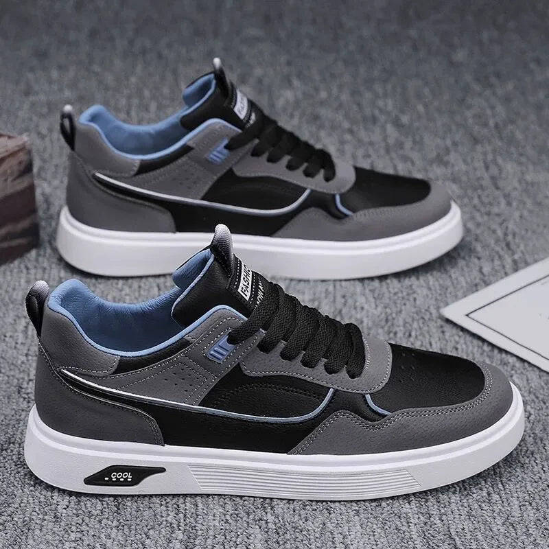 Men's low-top canvas board shoes in grey with leather stitching detail on a white background.