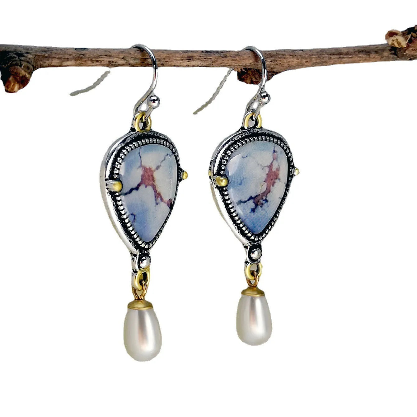 Retro blue geometric drop earrings with synthetic opal and pearl accents on white background