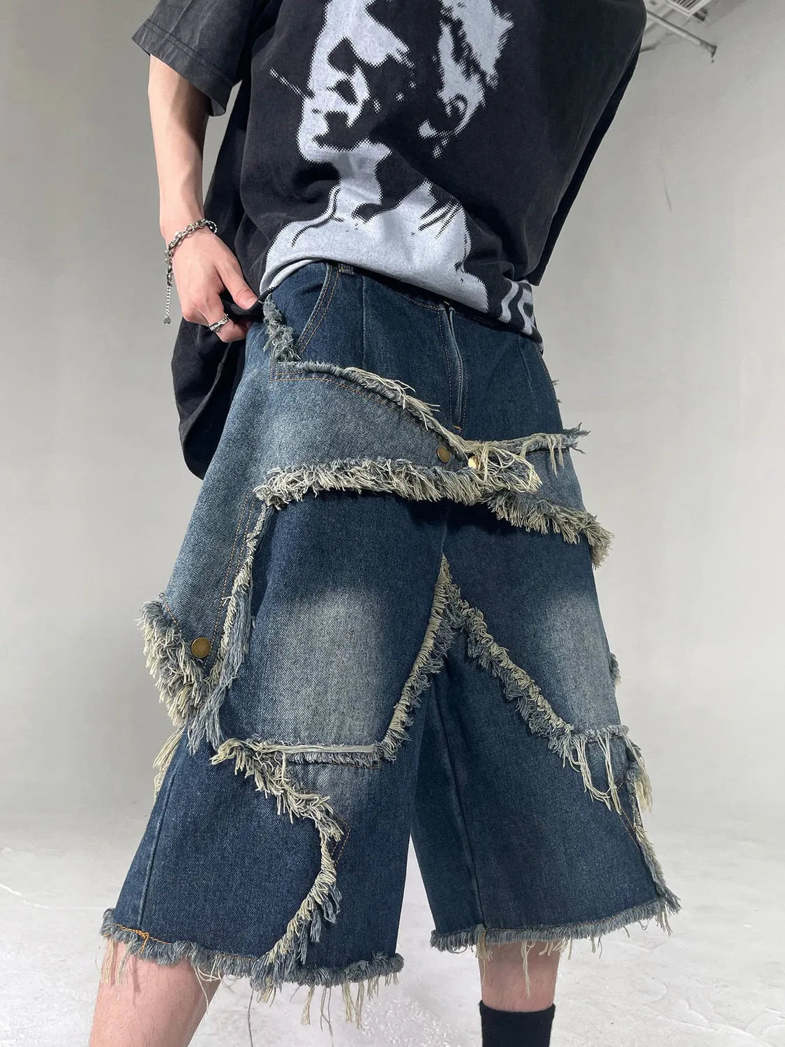 Blue retro denim shorts with frayed five-pointed star detail and loose fit design