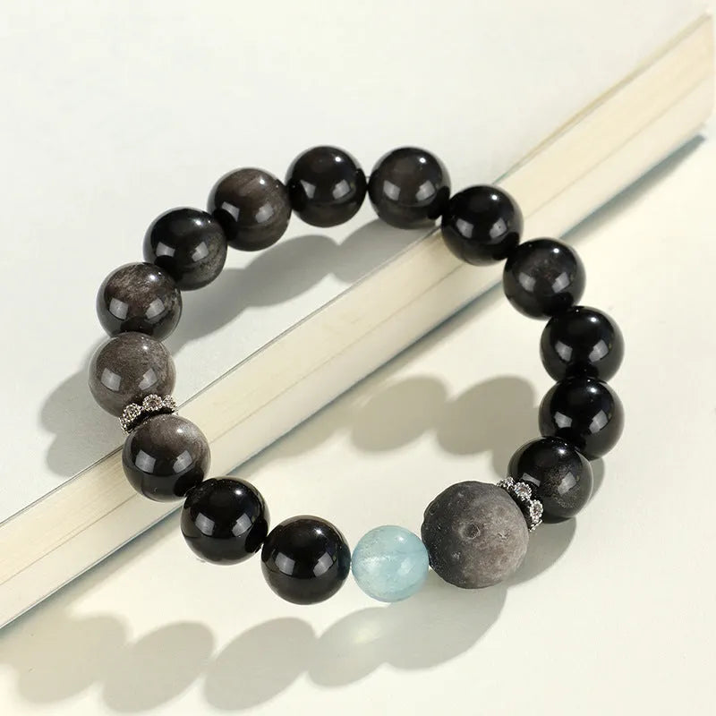 Silverstone crystal beaded bracelet with fox, cat head, and planet charms in white, pink, navy blue, and black.