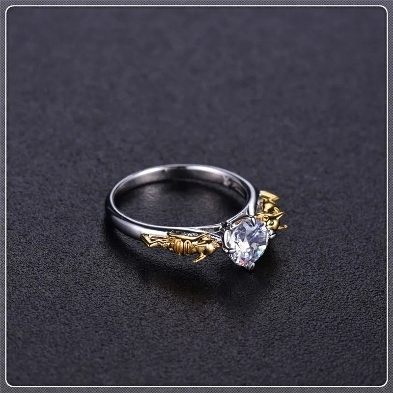 Detailed close-up of a black gold copper crown ring with a central crystal on a finger.