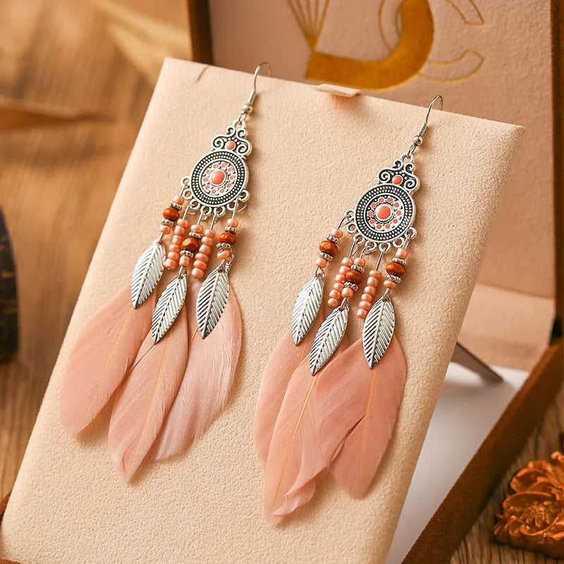 Round drop feather earrings in alloy with electroplated finish showing leaf shape and pattern details