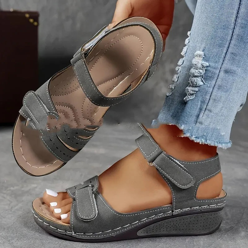 Women's beige strap sandals with thick composite sole and adjustable Velcro fastener on a white background.