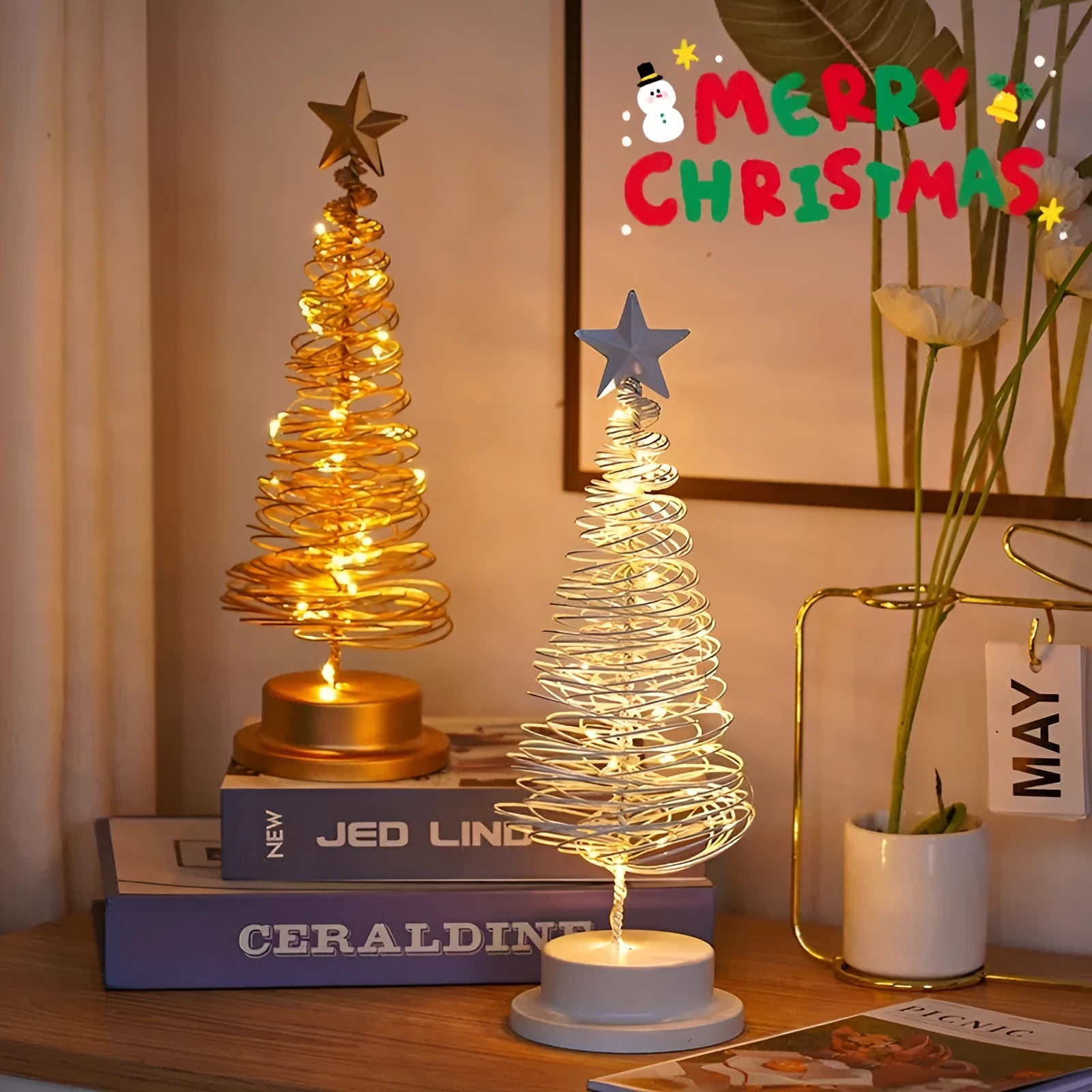 Wrought iron metal LED Christmas tree spiral light with warm white illumination on tabletop