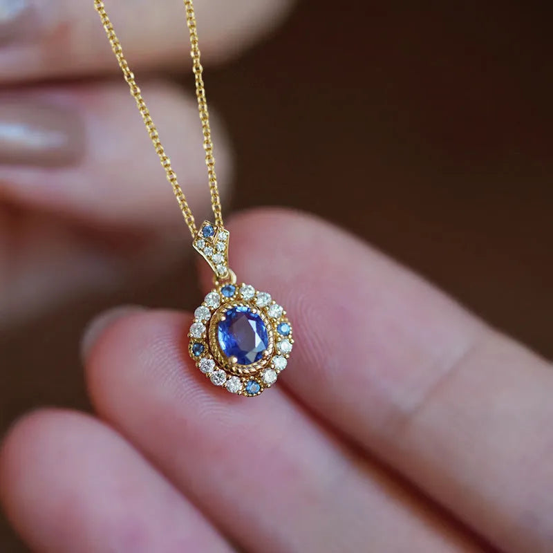 Yellow gold-tone women's necklace with adjustable box chain and a gemstone pendant featuring a central inlaid zircon.