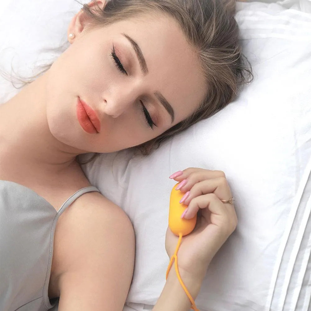 Hand-held micro-current sleep aid device with round button and USB charging port