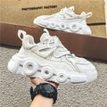 Men's low-top sneaker in grey with breathable mesh upper, thick rubber sole, round toe, and lace-up front.