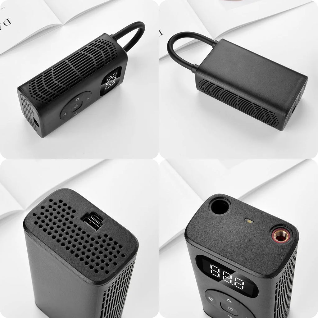 Black rectangular portable tyre inflator and power bank unit with a connected inflation hose on a table.