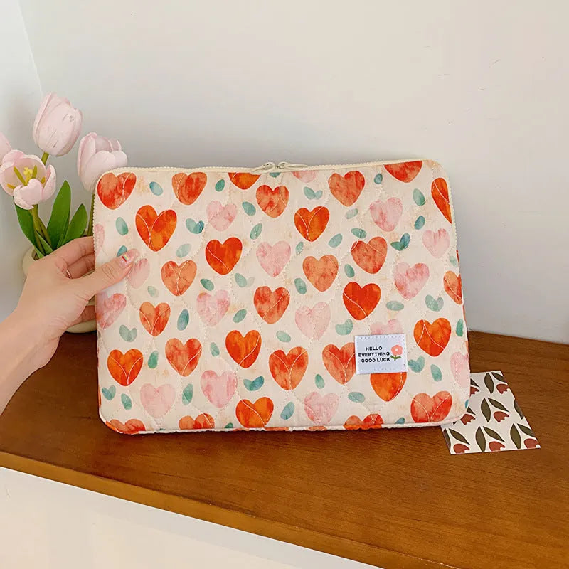 Women's printed floral cloth laptop bag shown in green flower pattern, available in small, medium, and large sizes.