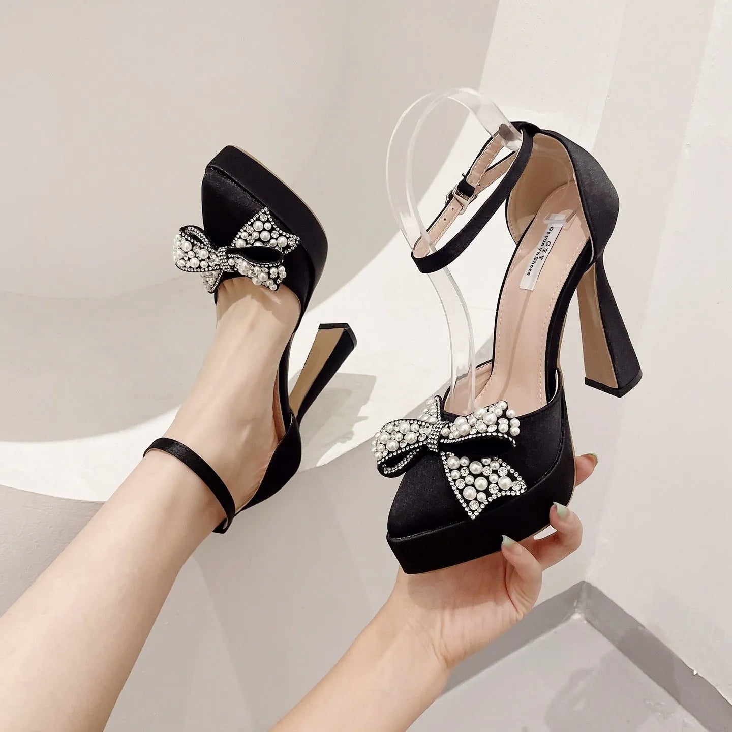 Women's black satin pointed-toe sandals with decorative bow detail and loop dressing
