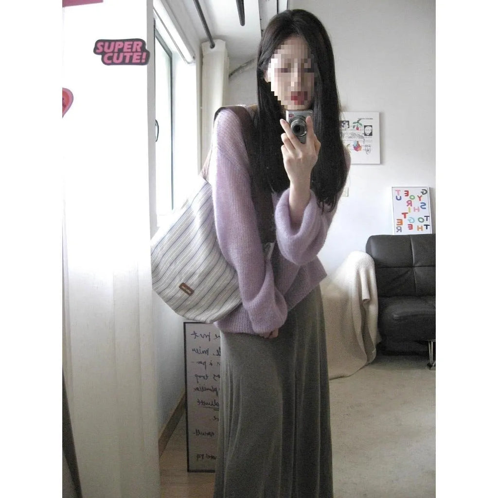 Purple women's sleeveless sweater with hollow-out design and shoulder strap detail.