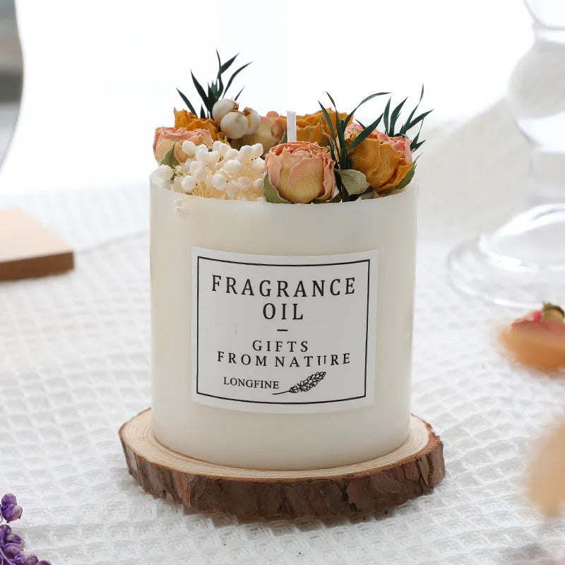 Decorative dried flower candle in jar with wooden chip base, available in nine botanical scents