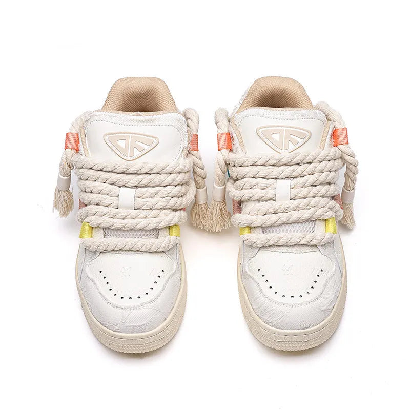 Creamy white Old Damage retro skate shoes with lace-up front and platform sole.