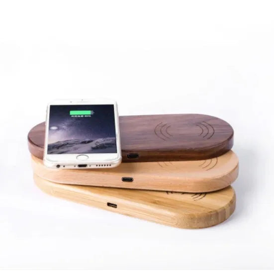 Wood wireless charger with natural bamboo finish showing Qi smartphone charging on top