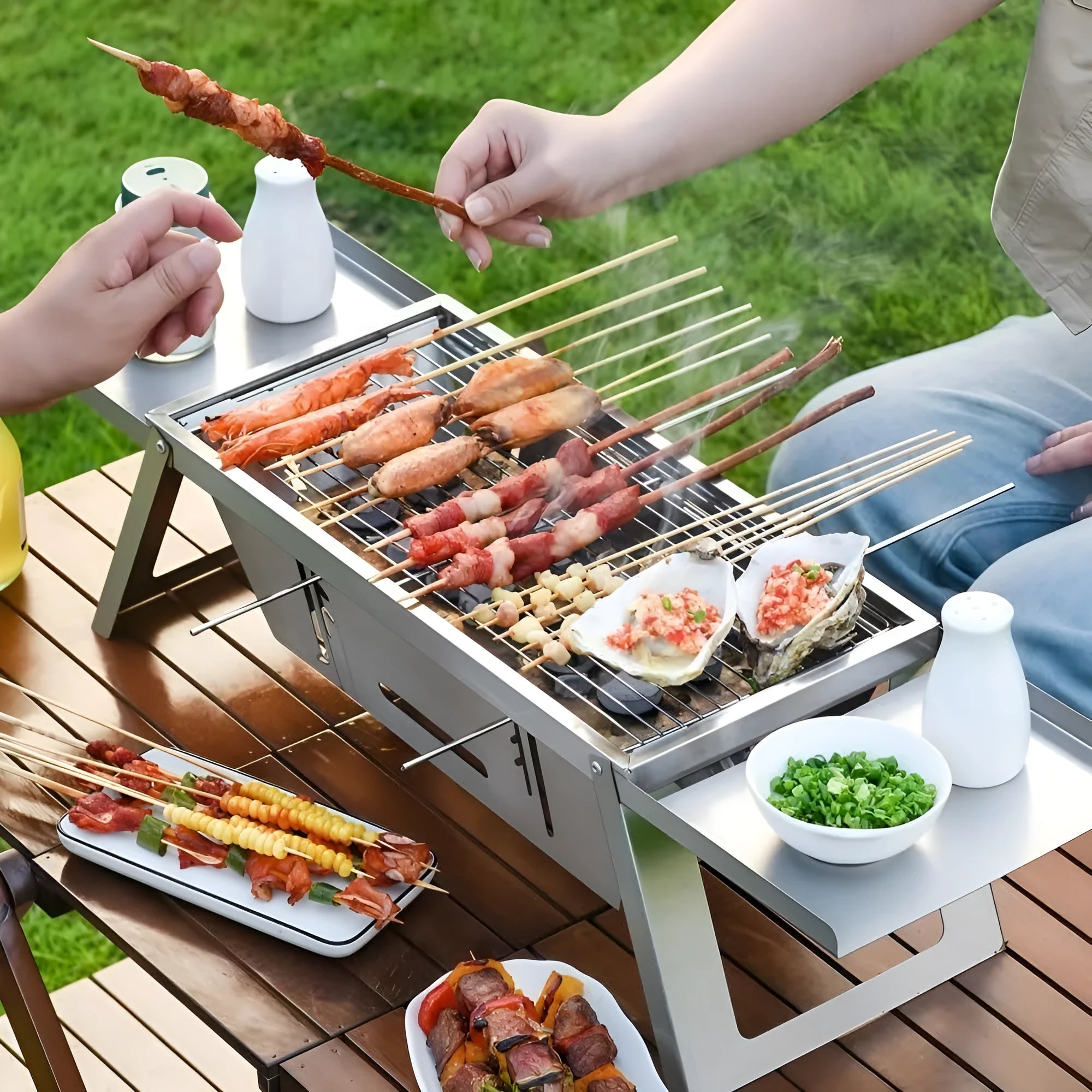 Small foldable portable charcoal grill with steel frame for outdoor cooking.
