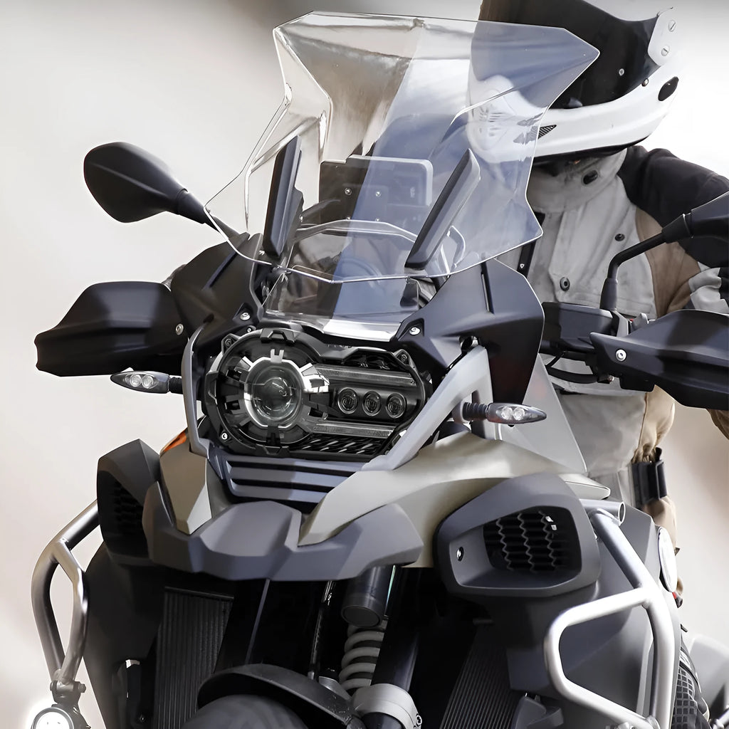 Black 7-inch round LED motorcycle headlight with a polycarbonate lens shown from the front.